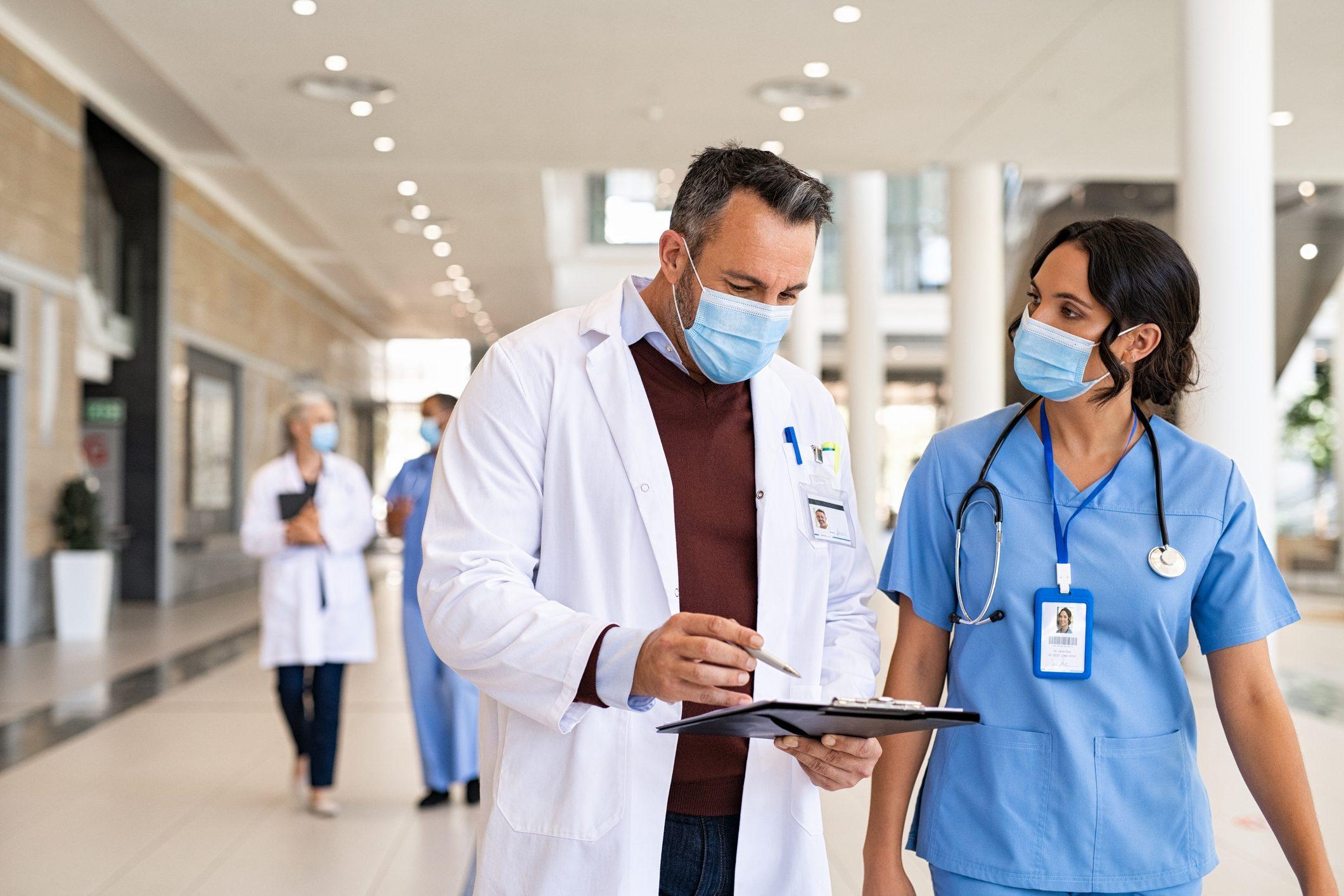 Healthcare professionals discussing patient care and clinical considerations that influence healthcare product standardization.