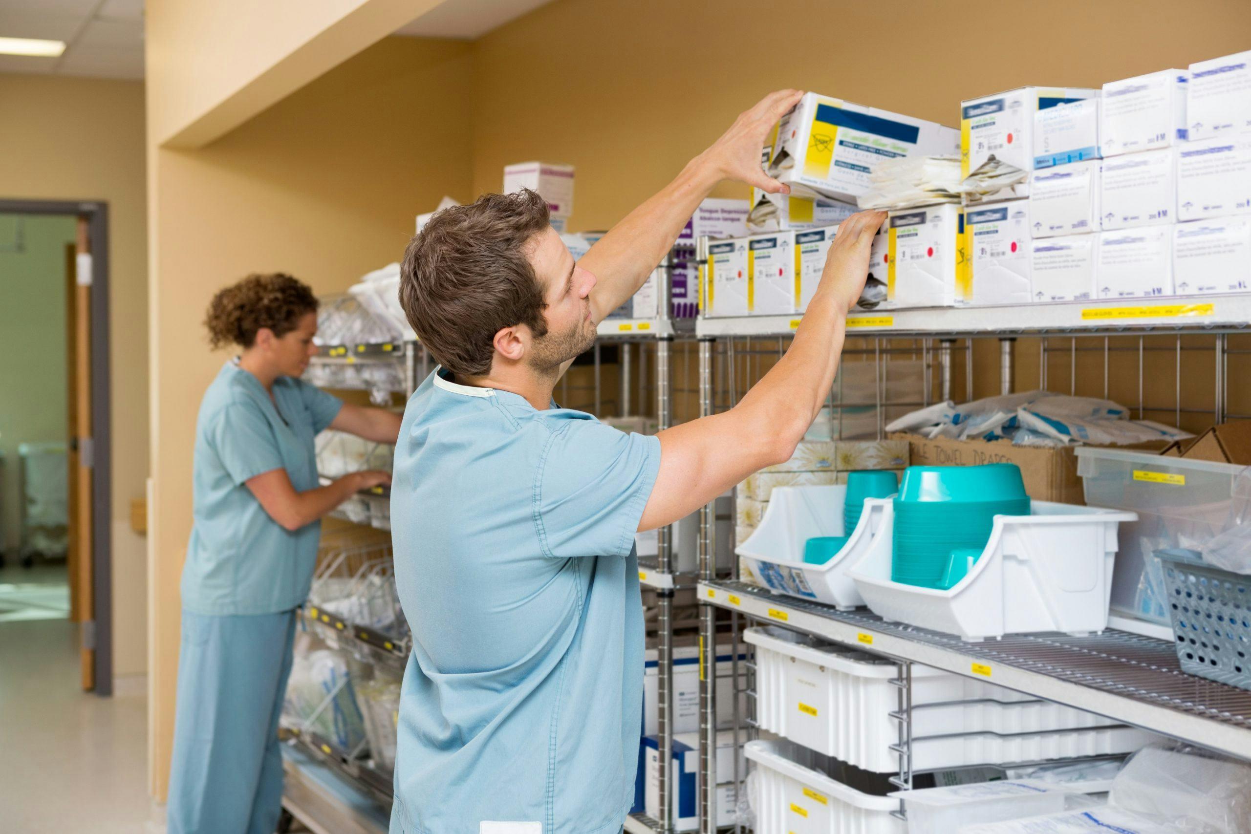 Healthcare professional managing medical supplies in a hospital, illustrating the operational impact of healthcare supplier performance.