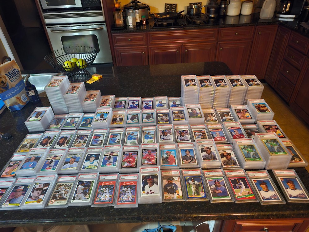 A table covered in graded card slabs