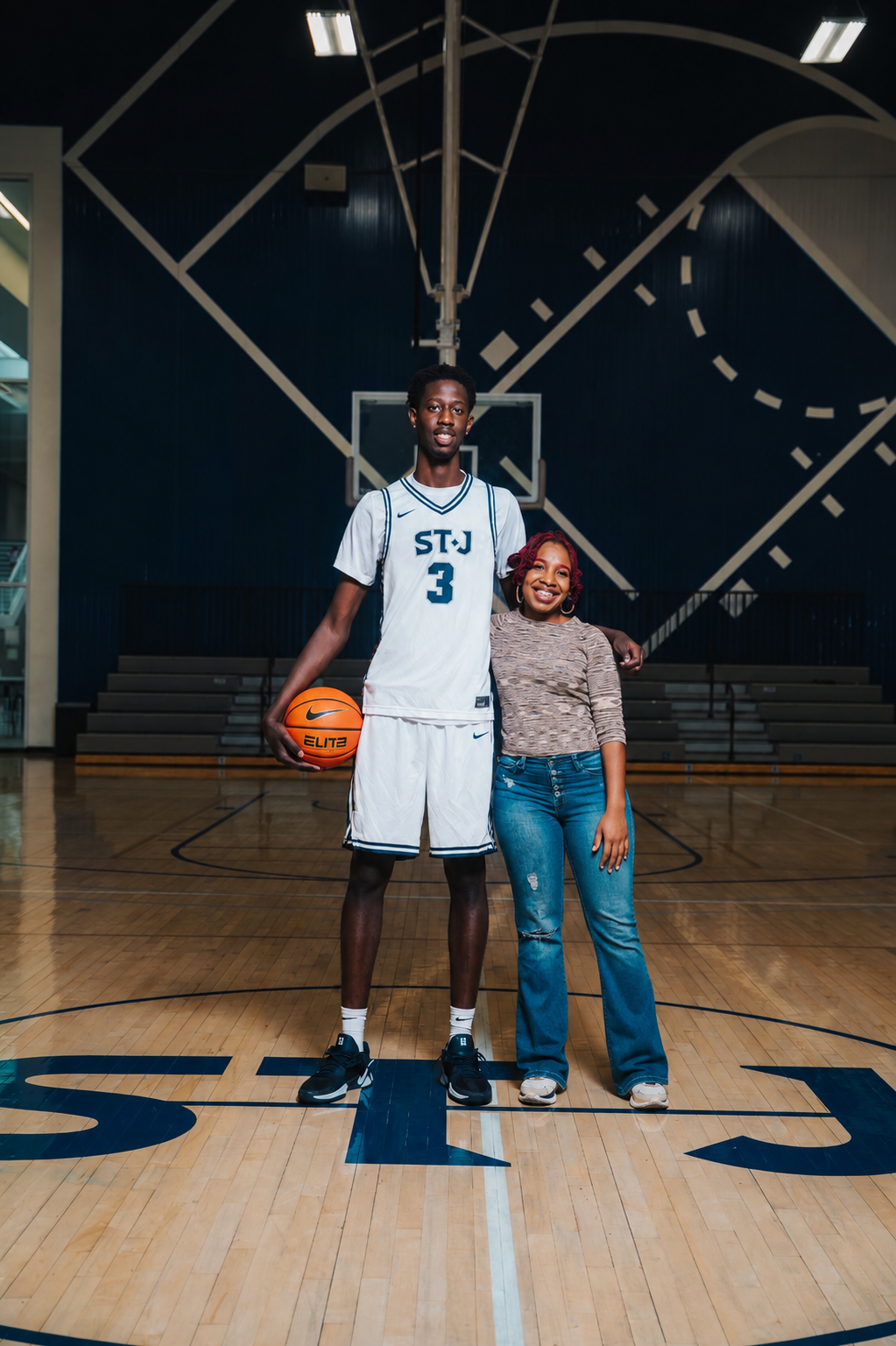 Dominique Stapleton with a family athlete in the basketball gym