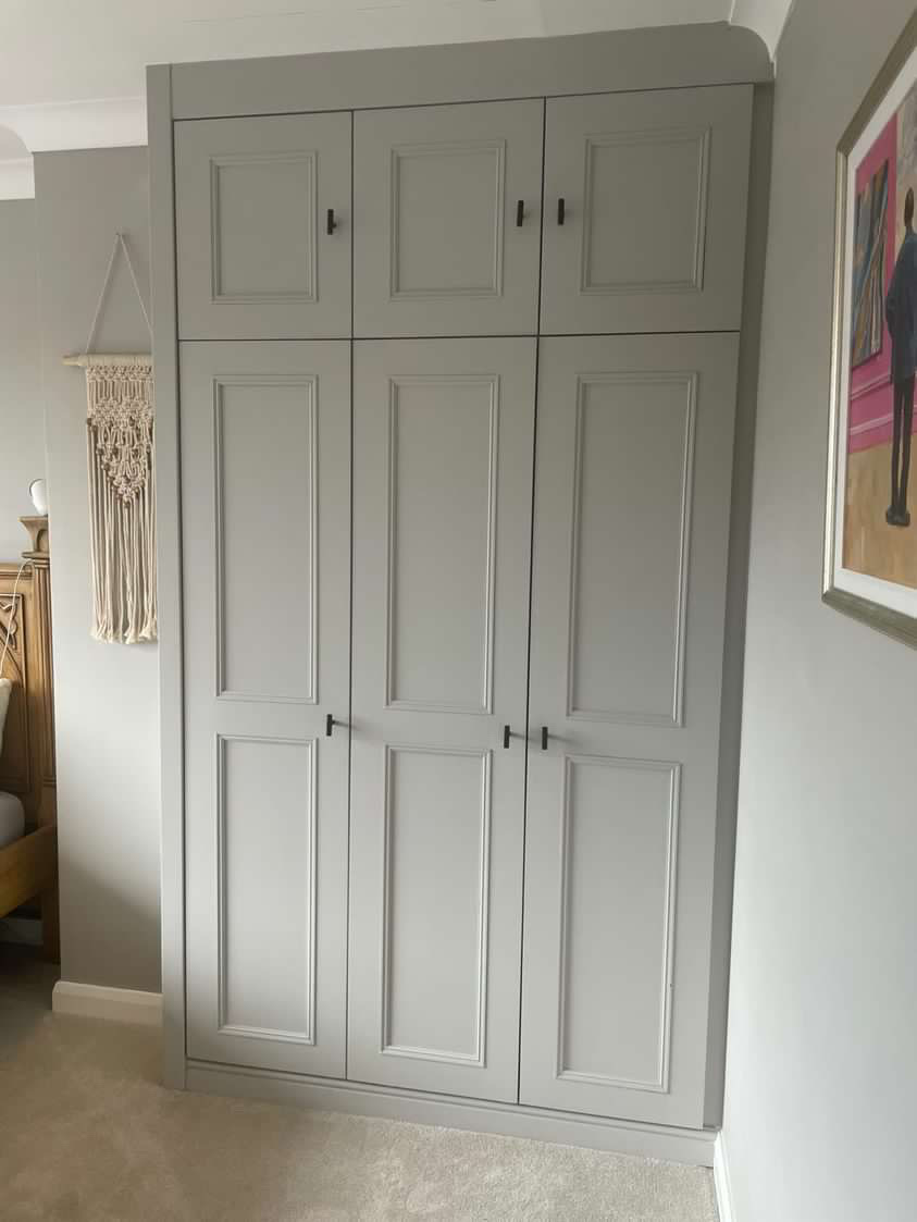 Bespoke fitted wardrobe with hinged doors and tailored interior storage, designed and installed in a Wetherby home by JAX Bespoke