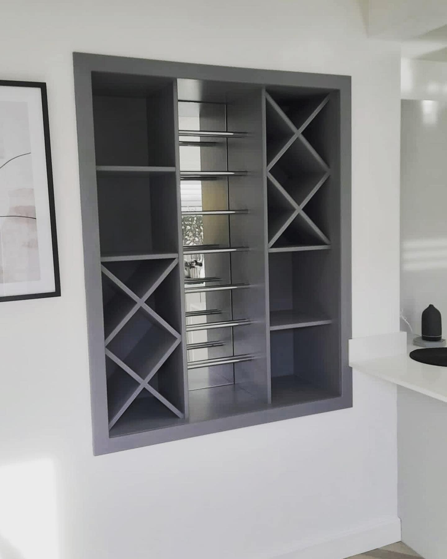 Bespoke fitted home bar and wine rack with integrated storage, handcrafted and installed by JAX Bespoke