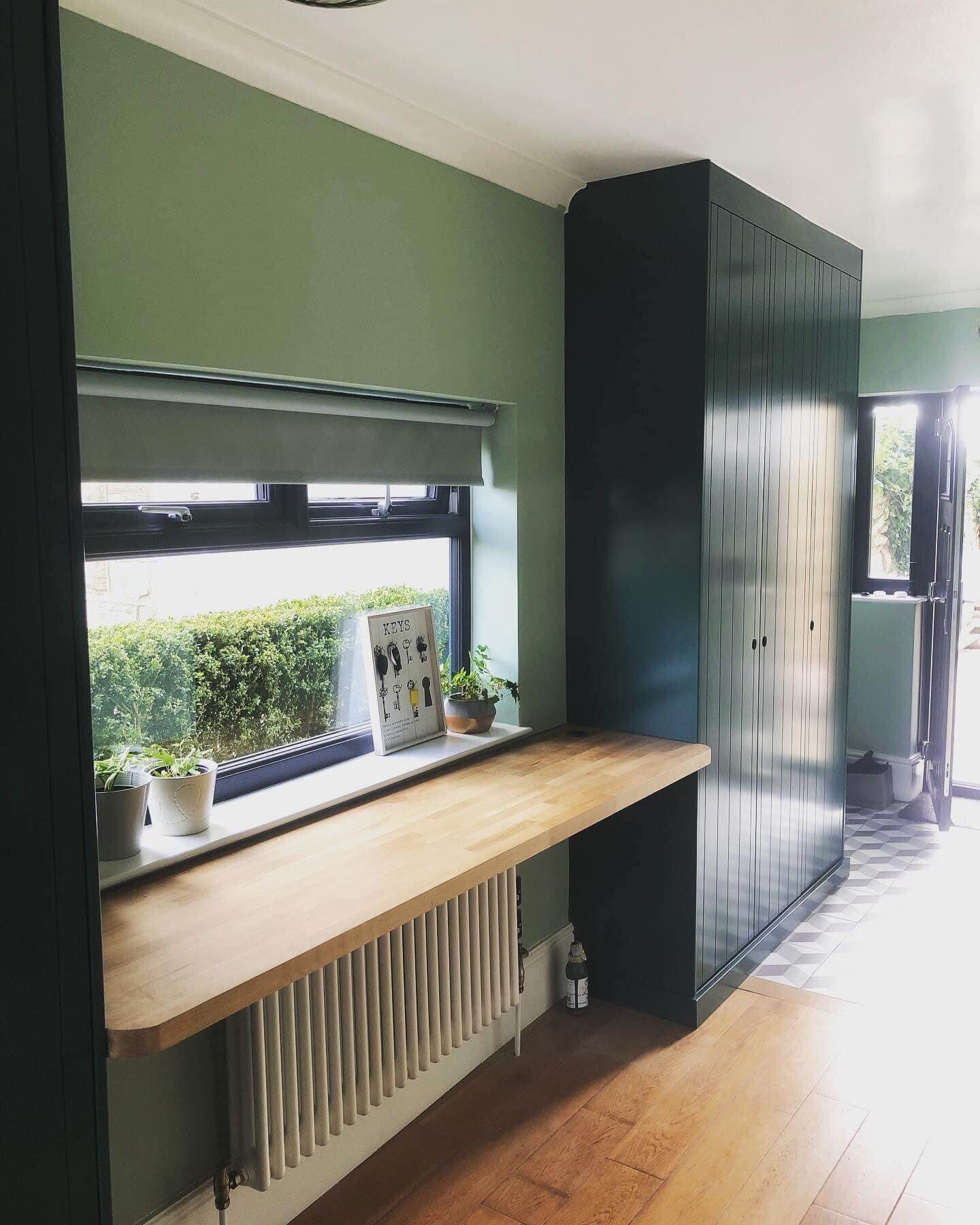 Bespoke fitted wardrobe with hinged doors and internal shelving, installed in a Leeds bedroom by JAX Bespoke