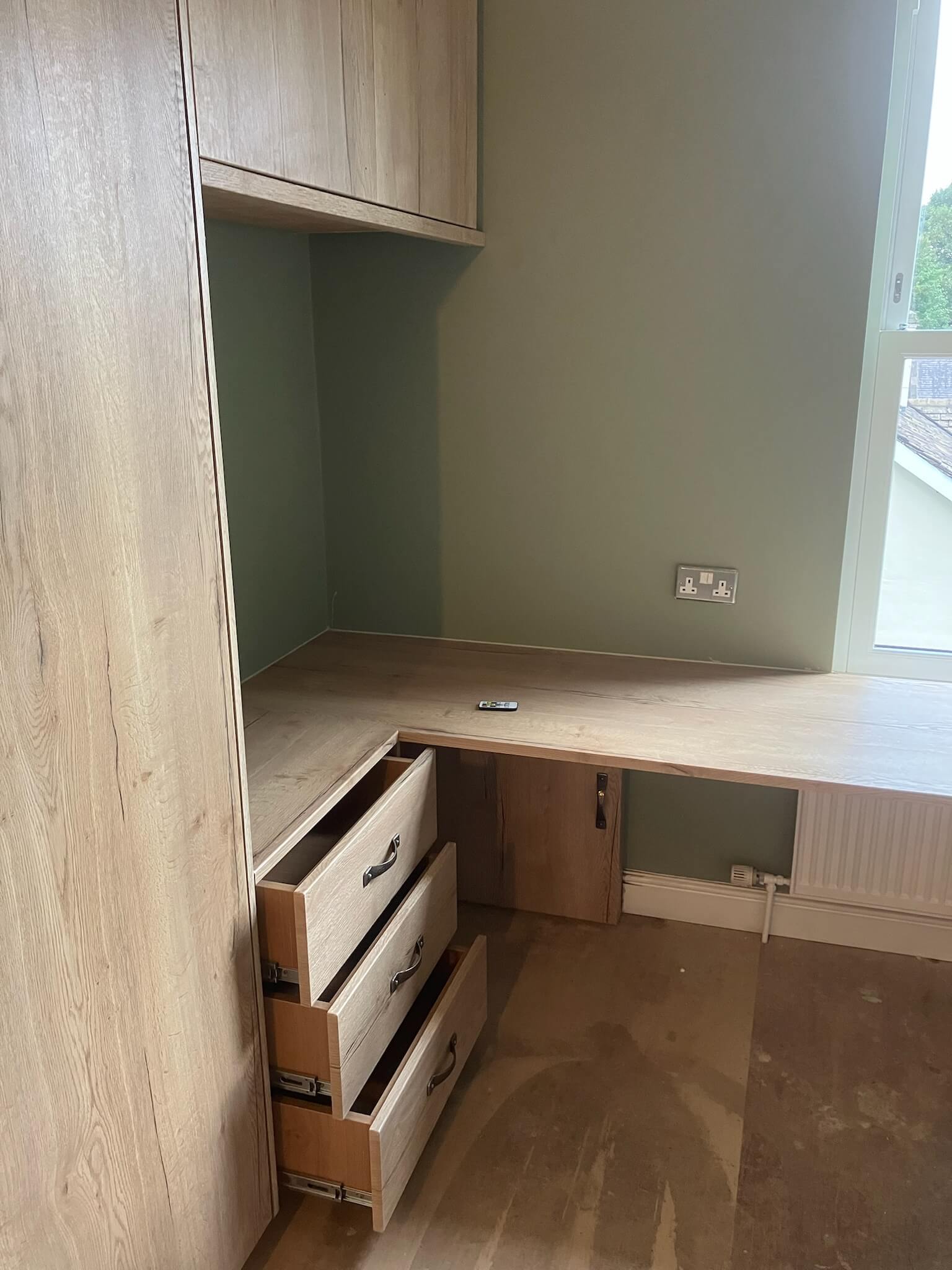 Bespoke fitted home office with integrated desk, shelving and concealed storage, by JAX Bespoke Leeds