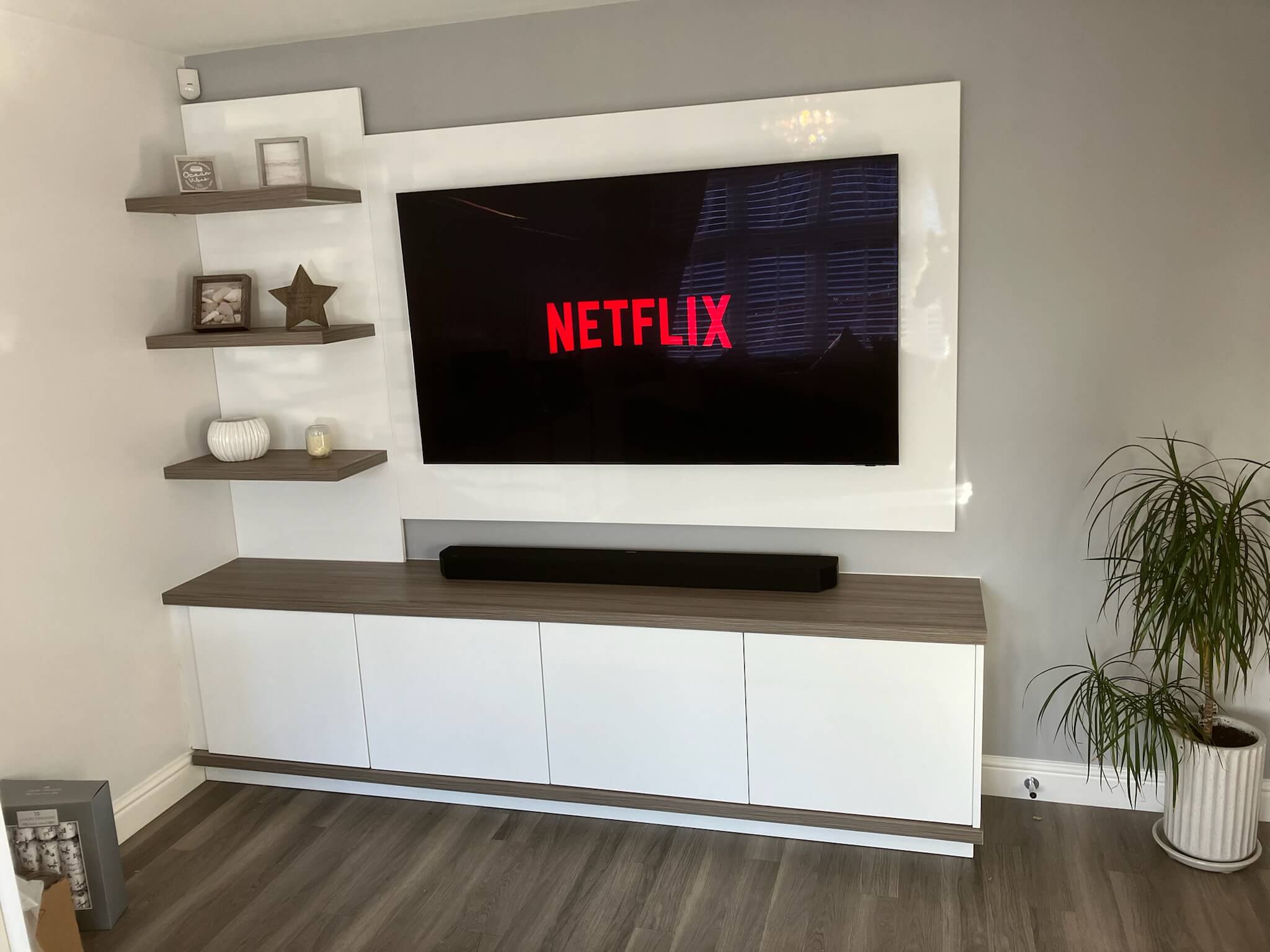Bespoke media wall with integrated TV unit, storage and shelving designed for a Wetherby living room, by JAX Bespoke