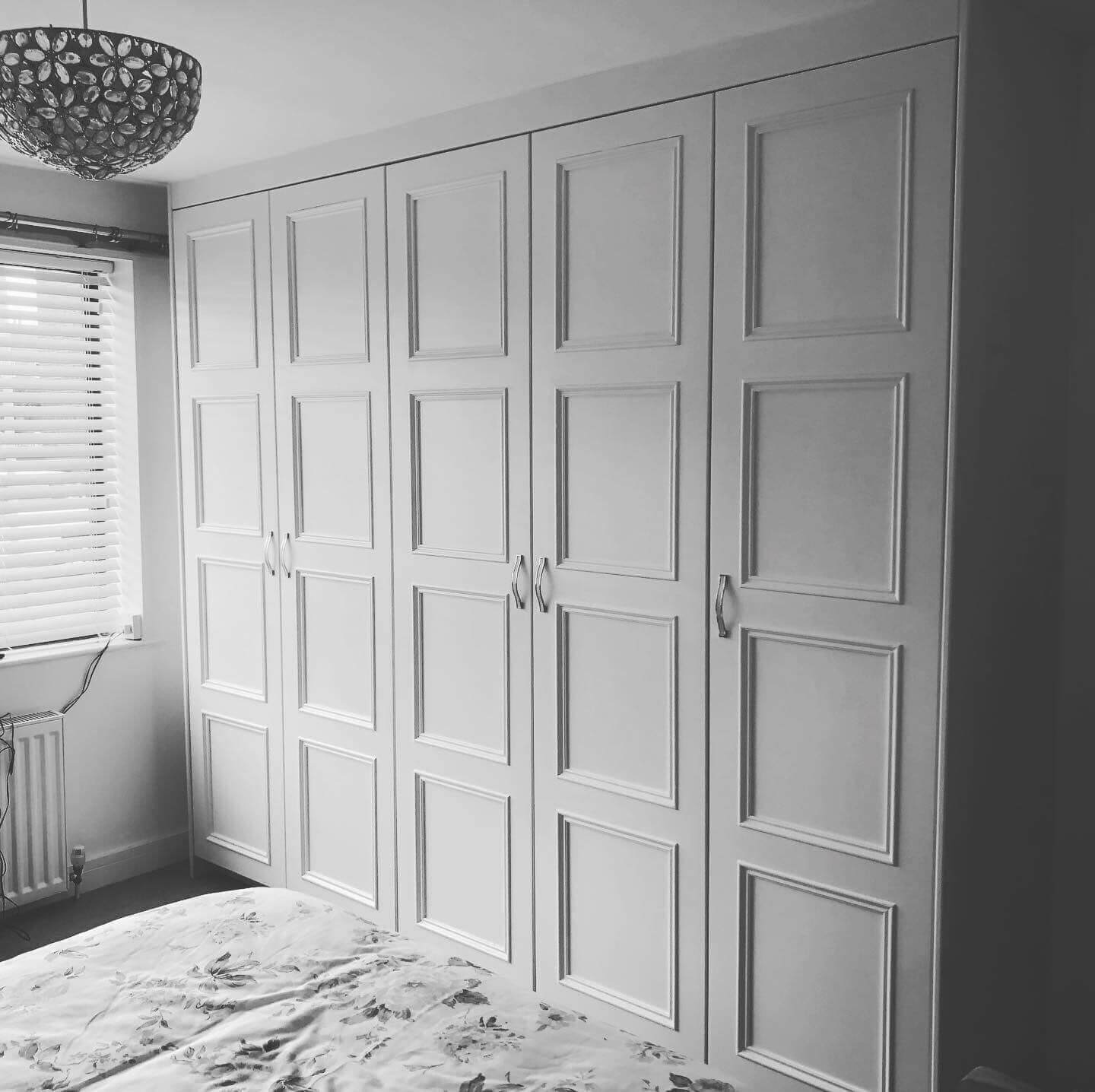 Bespoke fitted wardrobe with hinged doors and tailored interior storage, designed and installed in an Ilkley home by JAX Bespoke