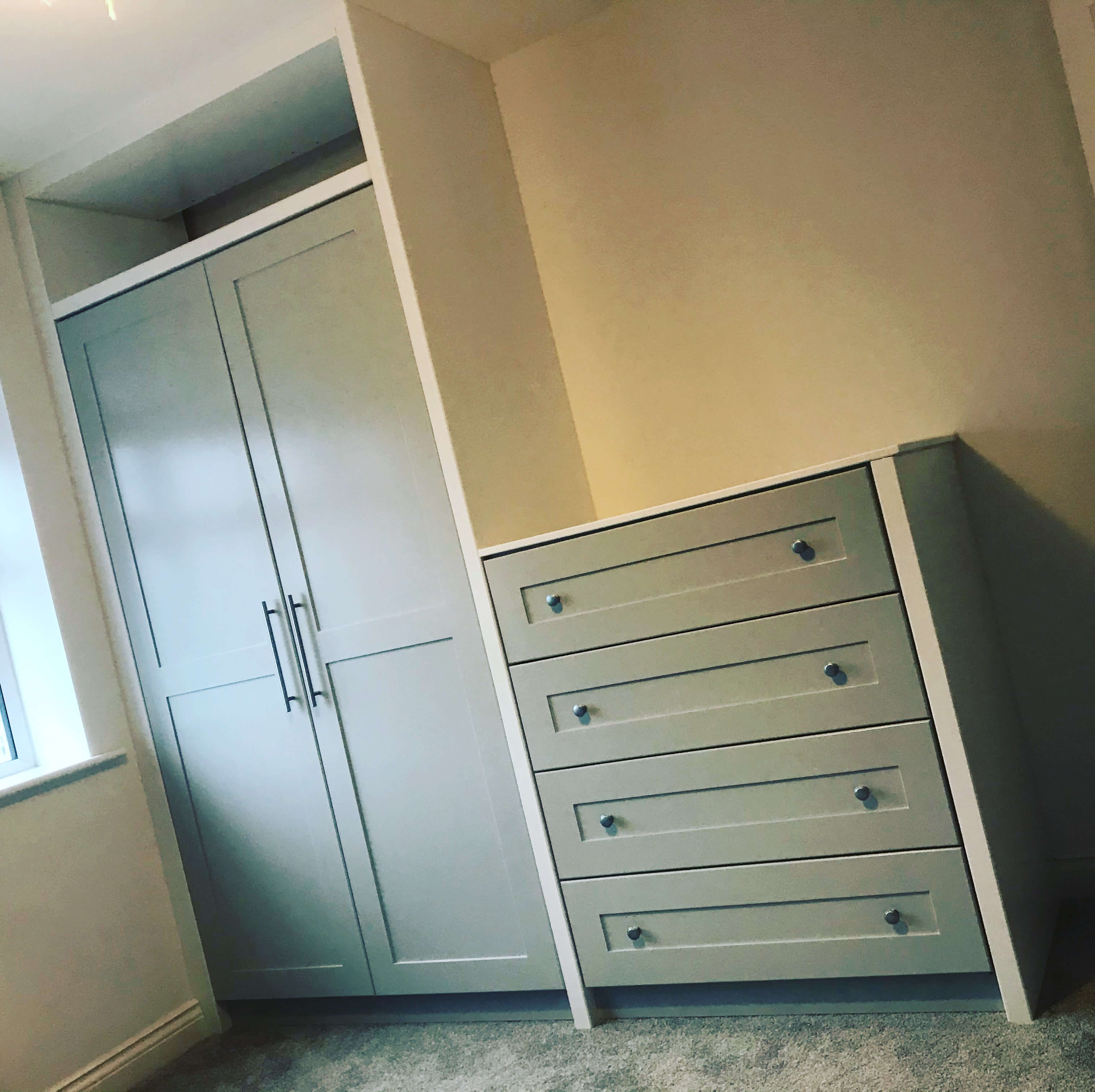 Bespoke fitted wardrobe with hinged doors and tailored interior storage, designed and installed in a Wakefield home by JAX Bespoke