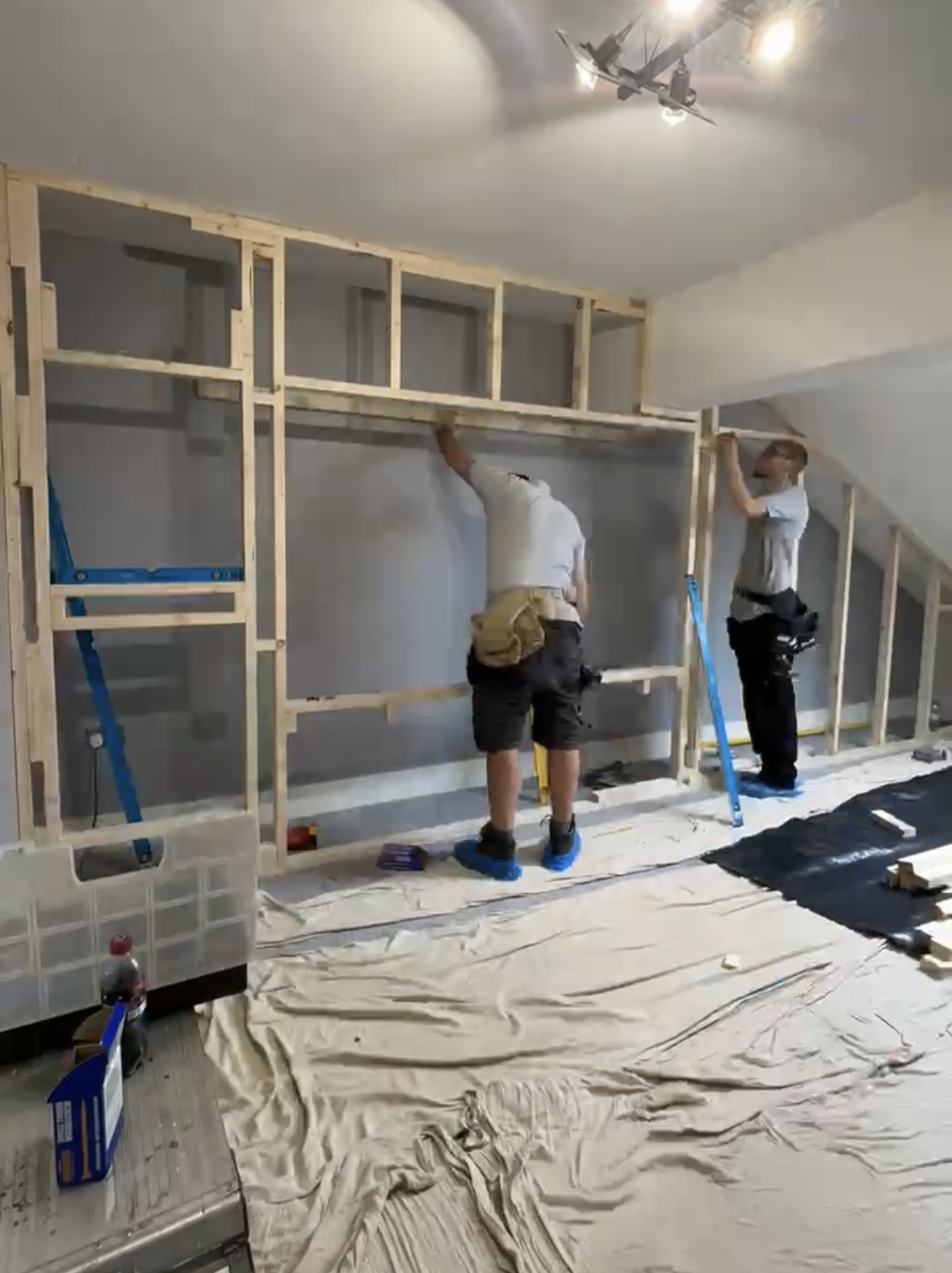JAX Bespoke team installing a timber frame for a custom-built media wall in a Leeds home