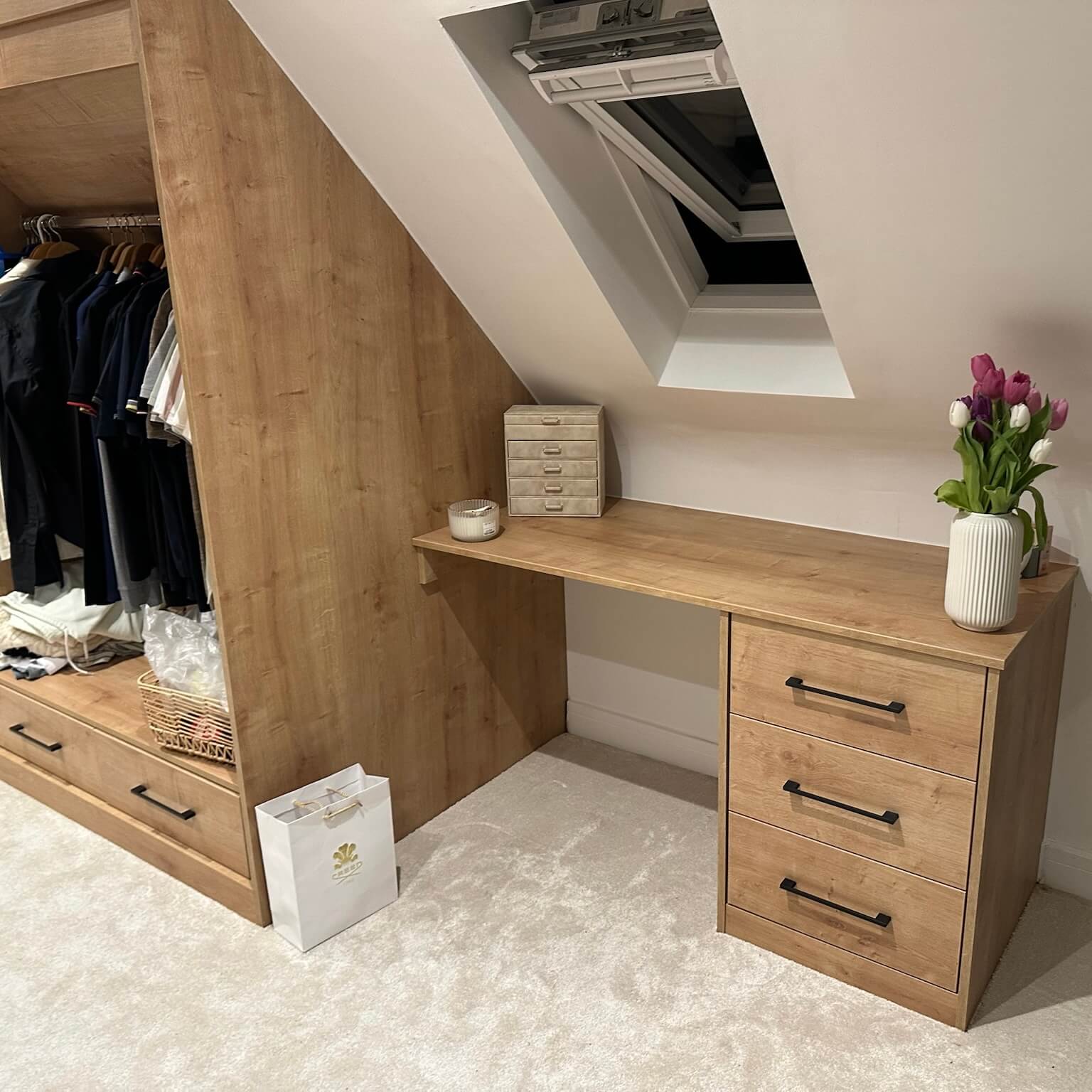Made-to-measure bedroom cabinetry built into a sloping loft ceiling, by JAX Bespoke