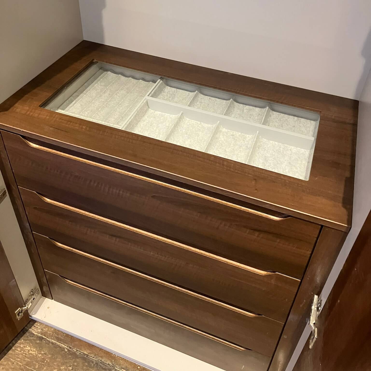Bespoke fitted wardrobe internal organisation showing hanging rails, shelving, drawers and pull-out storage, designed by JAX Bespoke