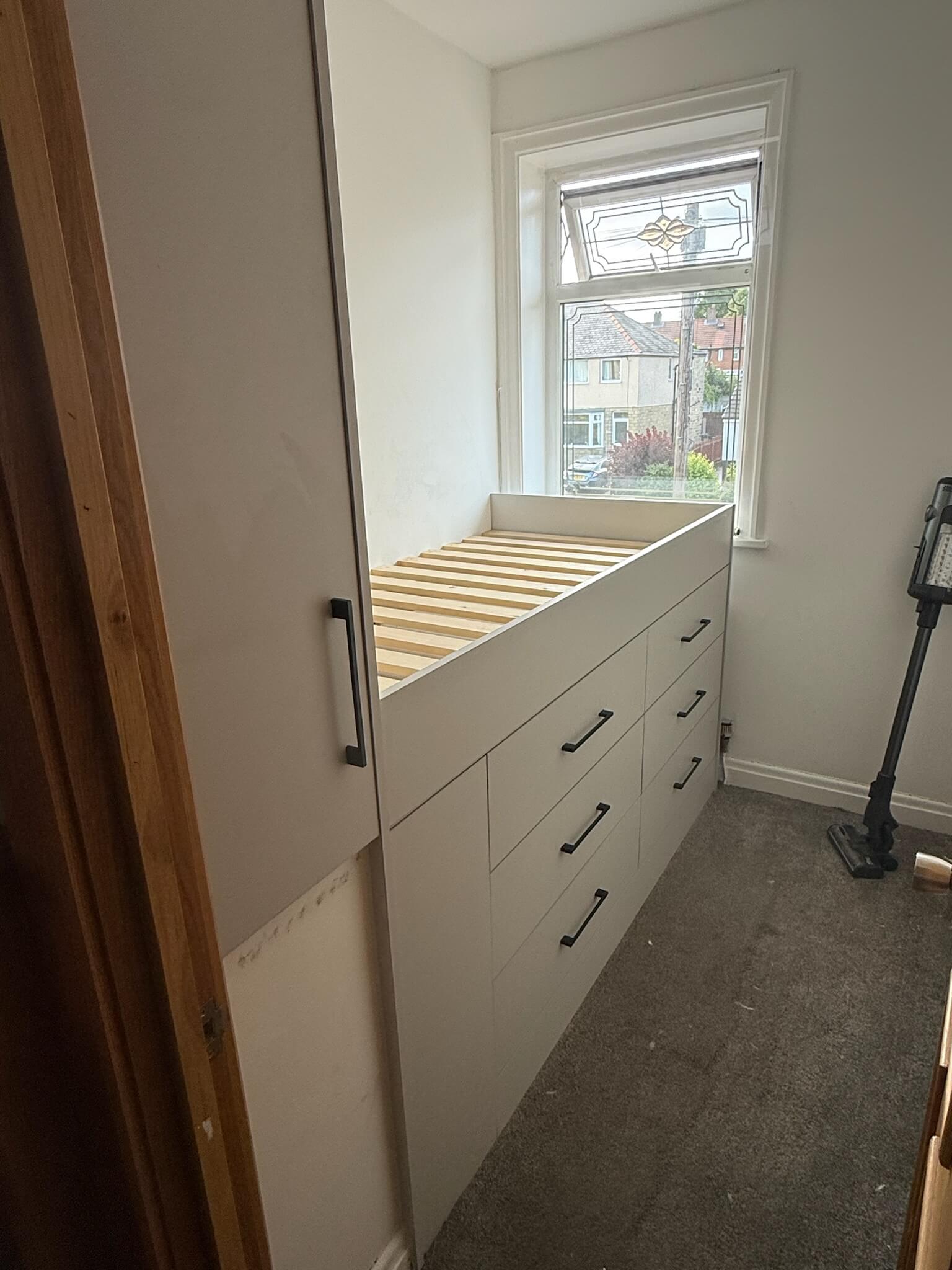 Built-in bed and storage in a small Wakefield bedroom, designed and installed by JAX Bespoke