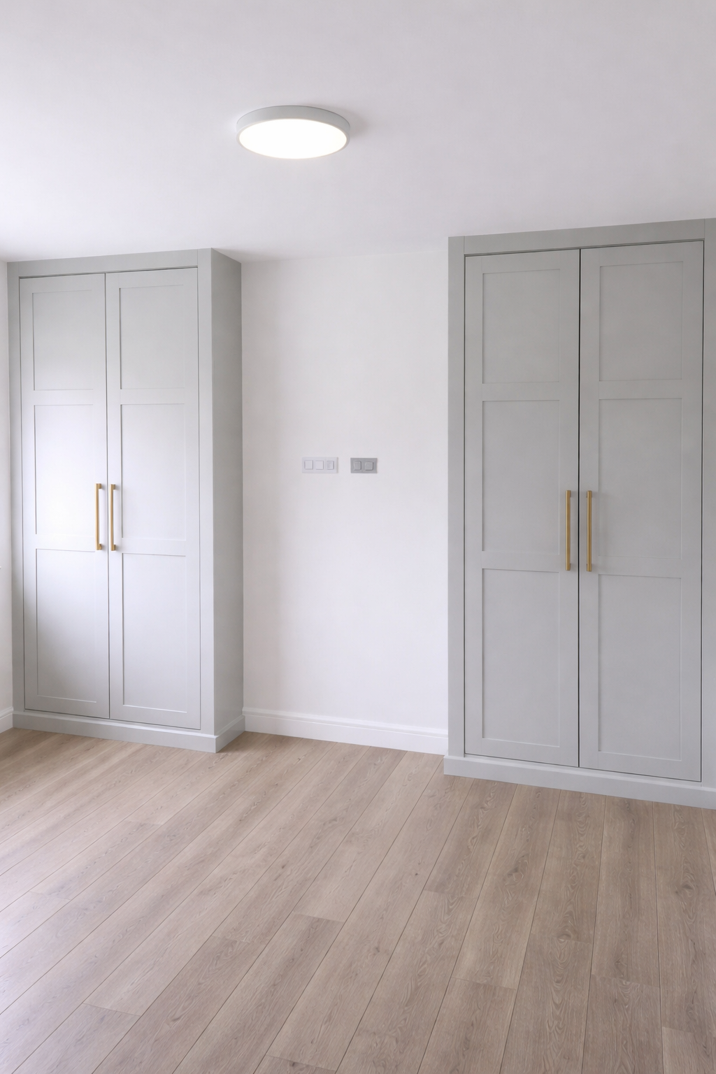pair of shaker style fitted wardrobes built into bedroom alcoves bespoke storage UK
