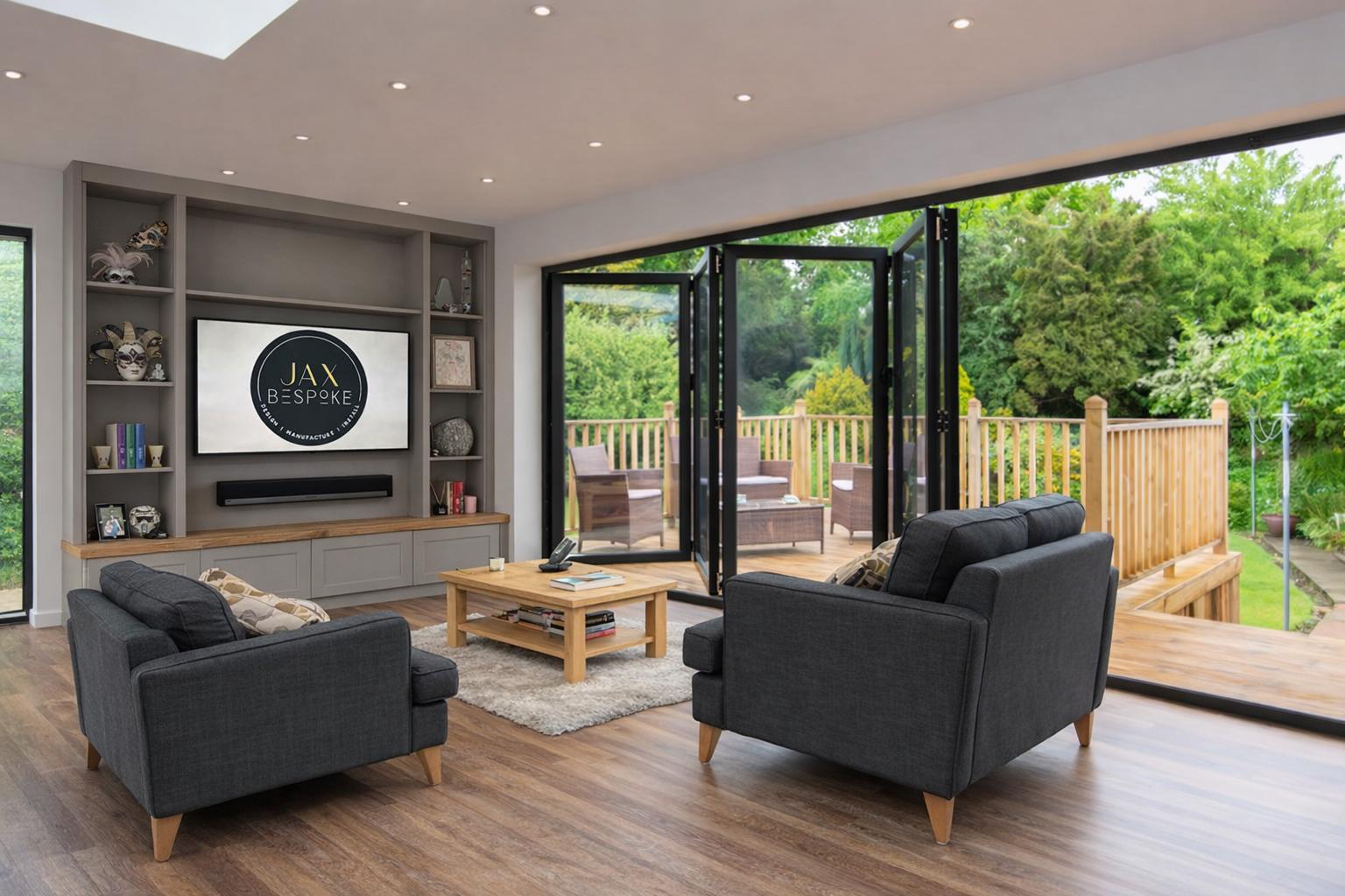 Bespoke fitted media wall with shelving and integrated soundbar in a modern living room with bifold doors overlooking the garden, custom furniture by JAX Bespoke.