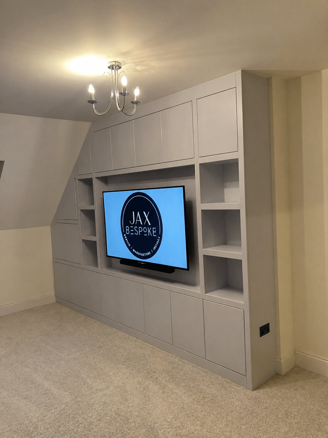 Bespoke media wall with integrated TV unit, shelving and storage built for a living room by JAX Bespoke