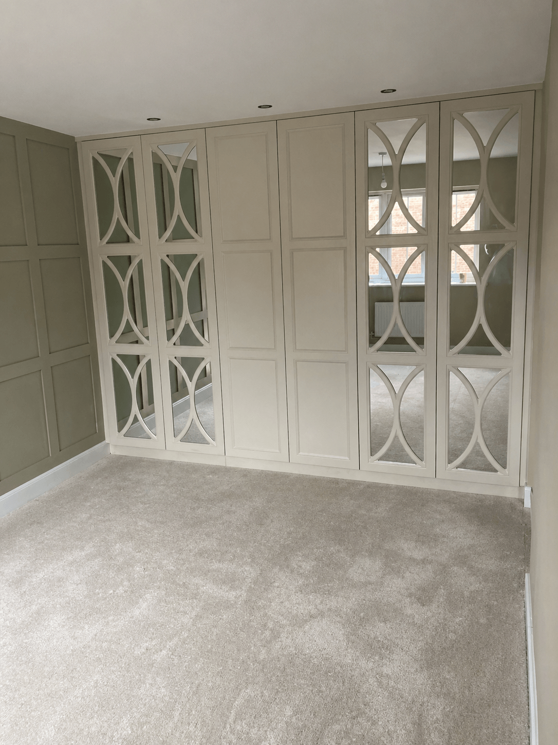Bespoke fitted wardrobe with hinged doors and tailored interior storage, designed and installed in a York home by JAX Bespoke