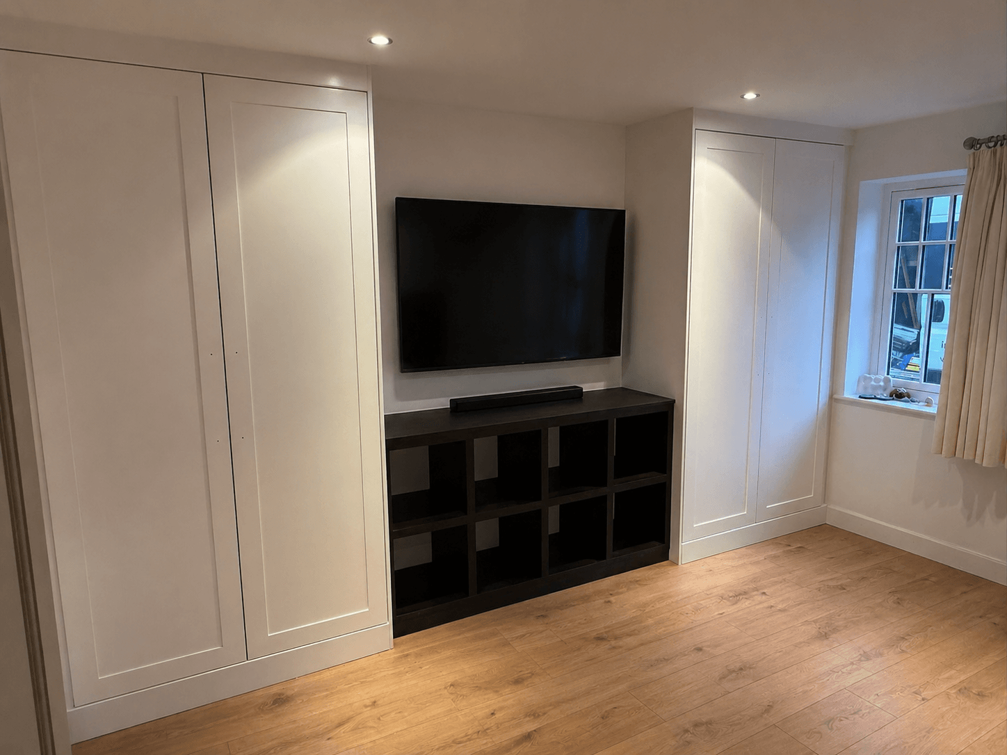 Bespoke bedroom furniture with fitted wardrobes and matching pieces designed as a cohesive scheme by JAX Bespoke