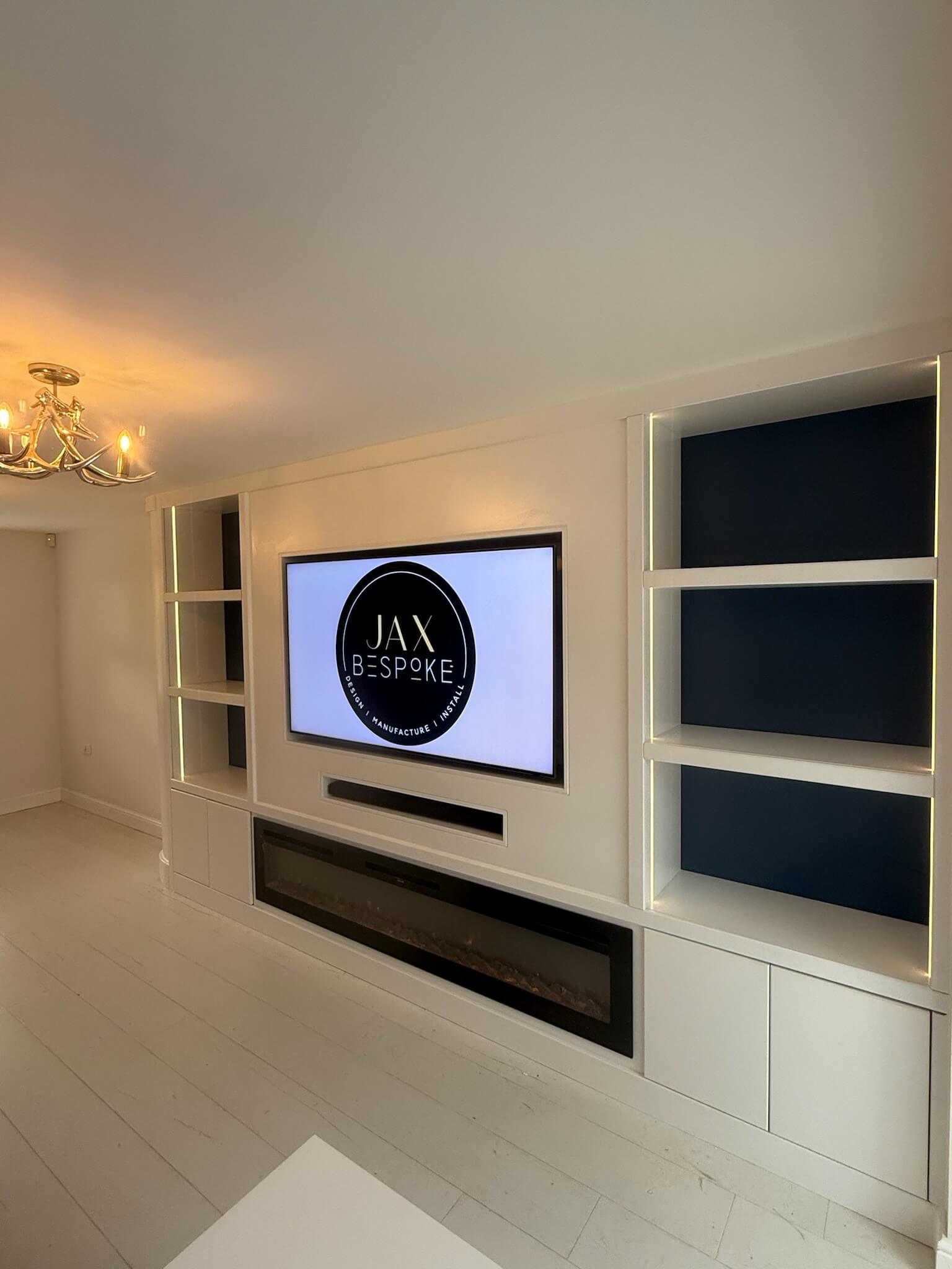 Bespoke media wall with integrated TV unit, storage and shelving designed for a living room by JAX Bespoke