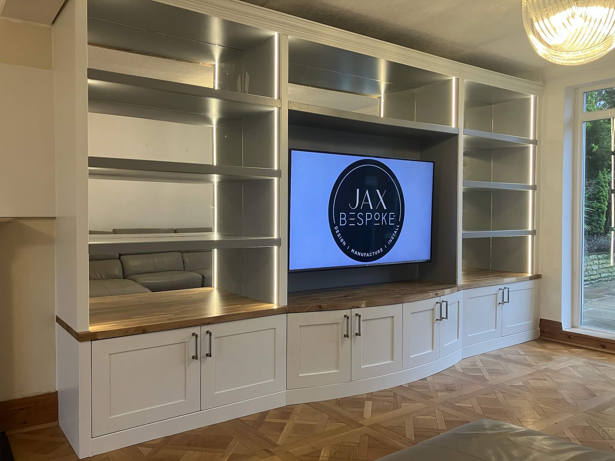 Bespoke media wall with integrated TV unit and cabinetry, designed and installed by JAX Bespoke