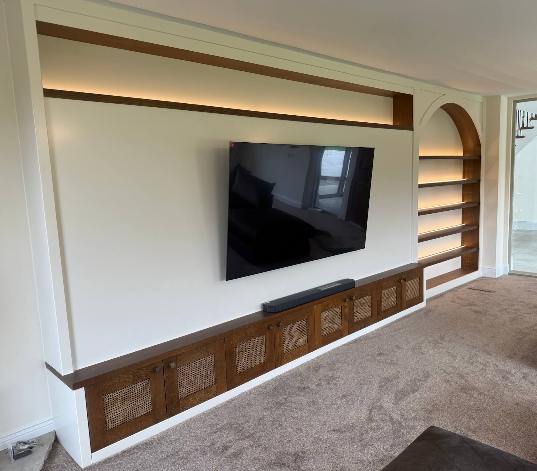 Bespoke full-wall cabinetry media wall with green finish and integrated TV housing, designed and installed by JAX Bespoke Yorkshire