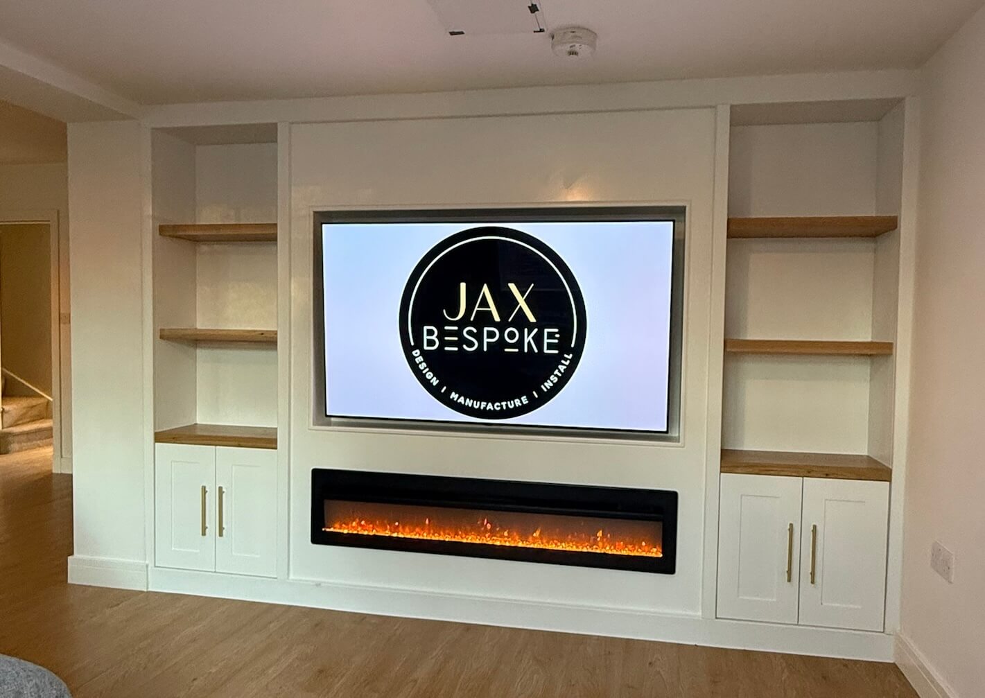 Bespoke cabinetry media wall in an open-plan kitchen living space, designed to flow with the room by JAX Bespoke Yorkshire
