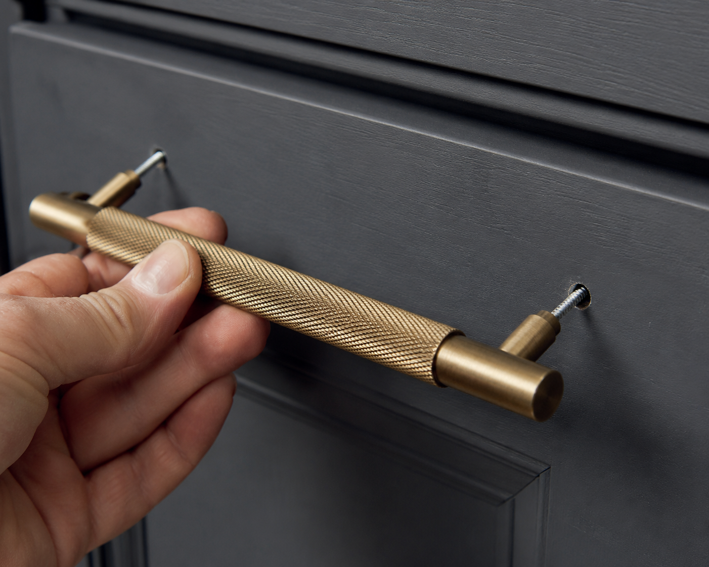 Close-up of a cabinet handle being fitted by JAX Bespoke — handcrafted joinery detail