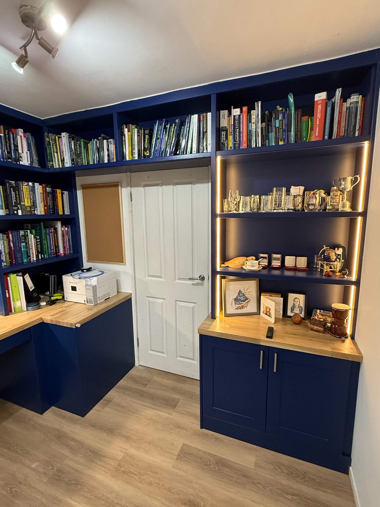 Navy blue full-room home office showing LED display shelving and fitted cabinetry, designed and installed by JAX Bespoke Yorkshire