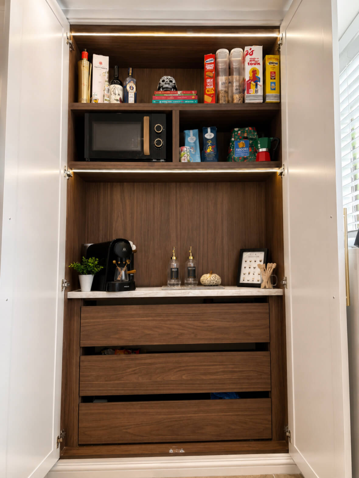 Bespoke fitted pantry with integrated coffee station, drawer storage and LED lighting, designed by JAX Bespoke