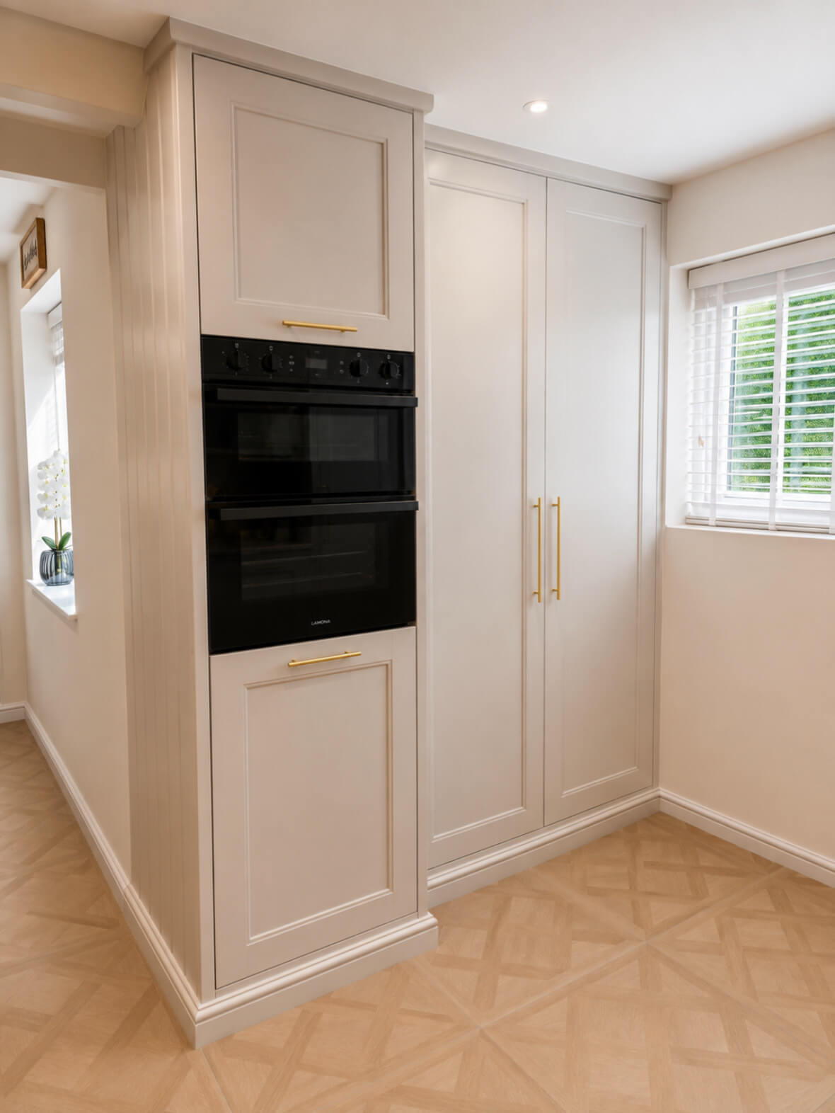 Bespoke shaker style kitchen with painted cabinetry, integrated ovens and brass hardware, handcrafted and installed by JAX Bespoke Yorkshire