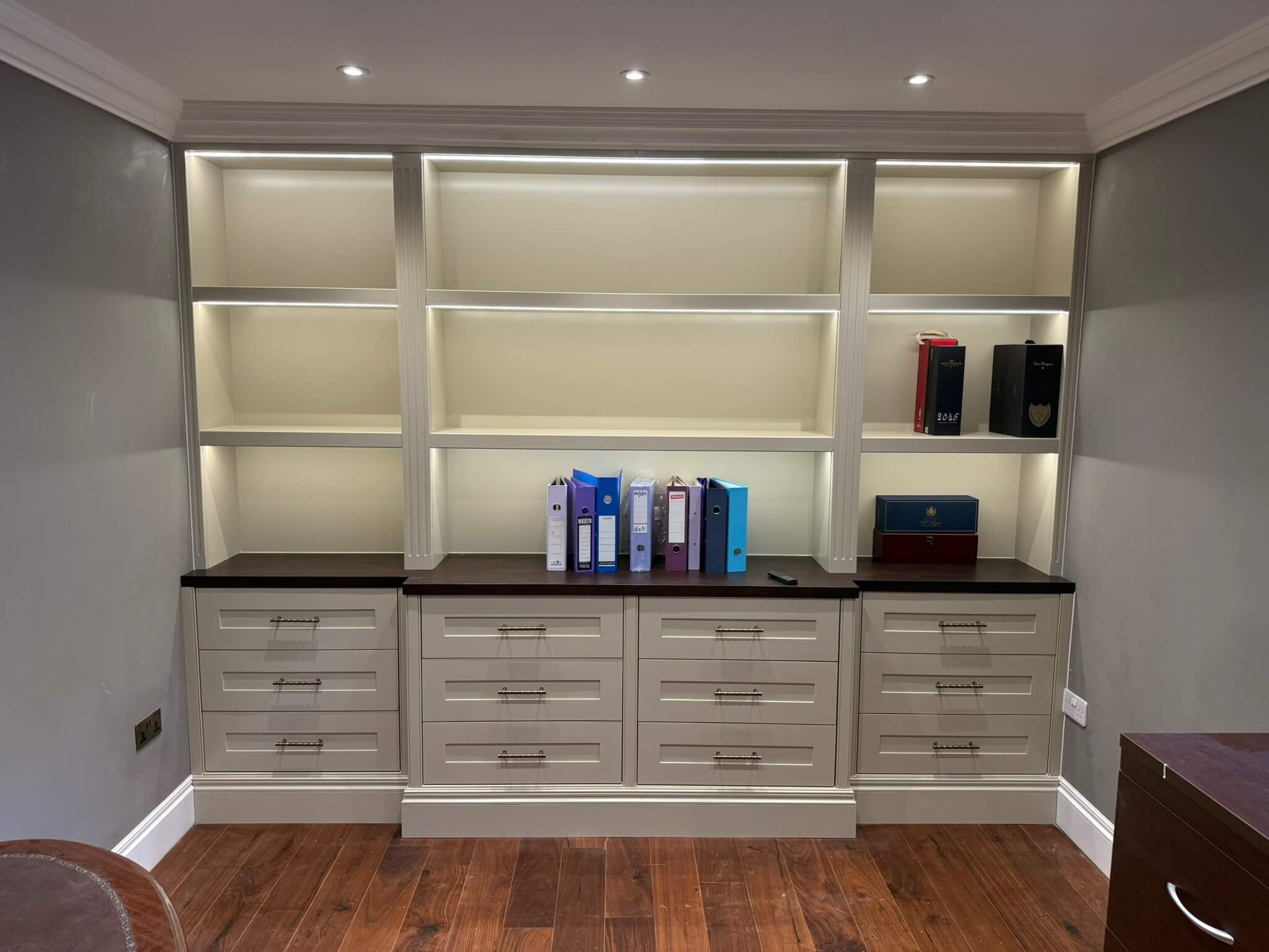Bespoke fitted shelving and drawer unit with LED lighting and dark wood worktop, handcrafted and installed by JAX Bespoke Yorkshire