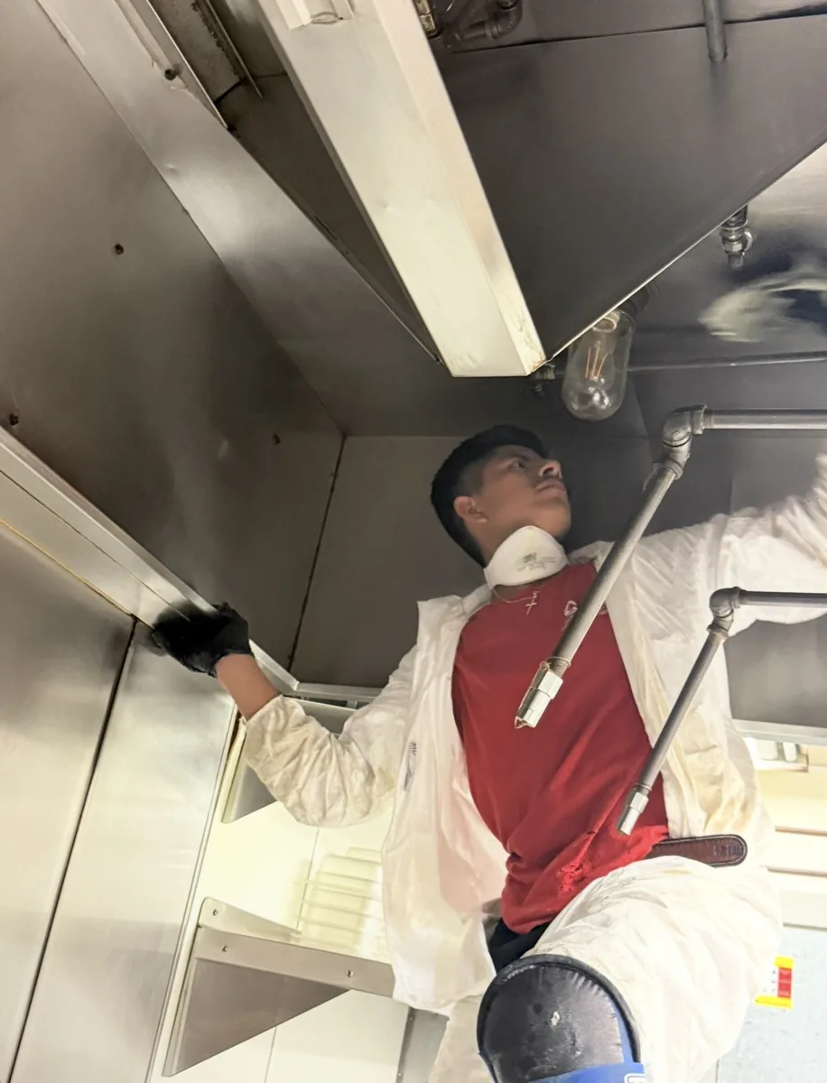 CCS employee performing commercial kitchen cleaning