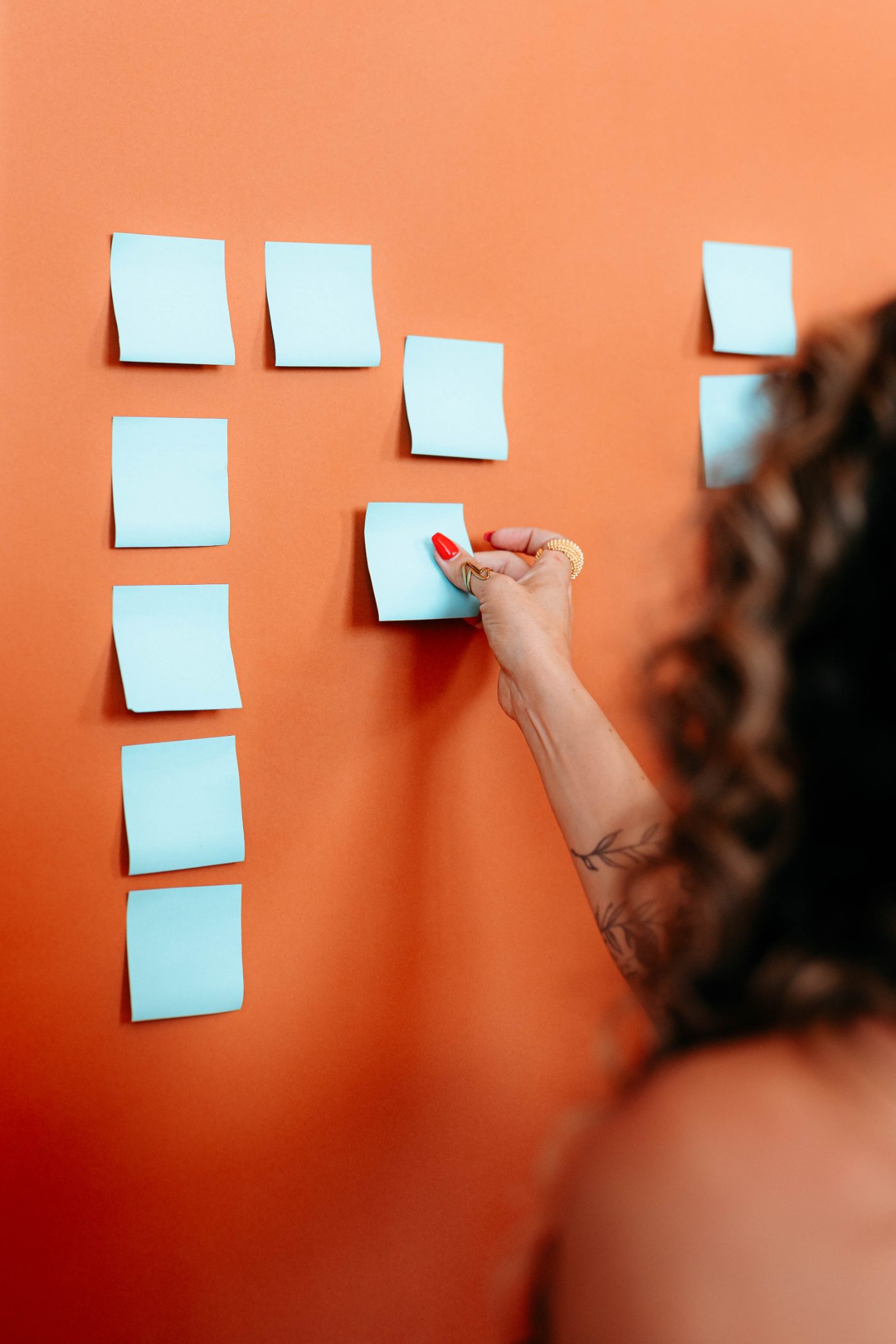 Dr. Lauryn at a wall of sticky notes