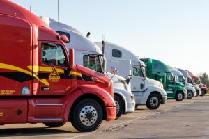 Row of semi truck cabs lined up for on-site fleet washing