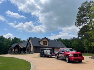River Valley Exterior Cleaning truck and equipment trailer set up outside a home in Russellville, Arkansas