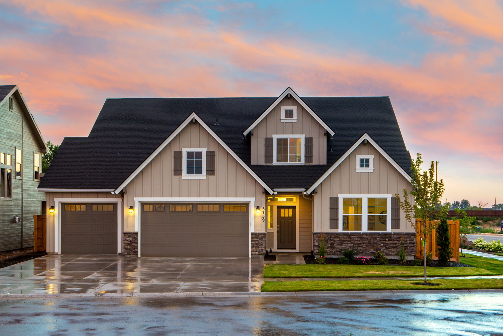 Modern detached investor house at sunset with lit windows and wet driveway, typical of Greater Toronto Area residential rentals