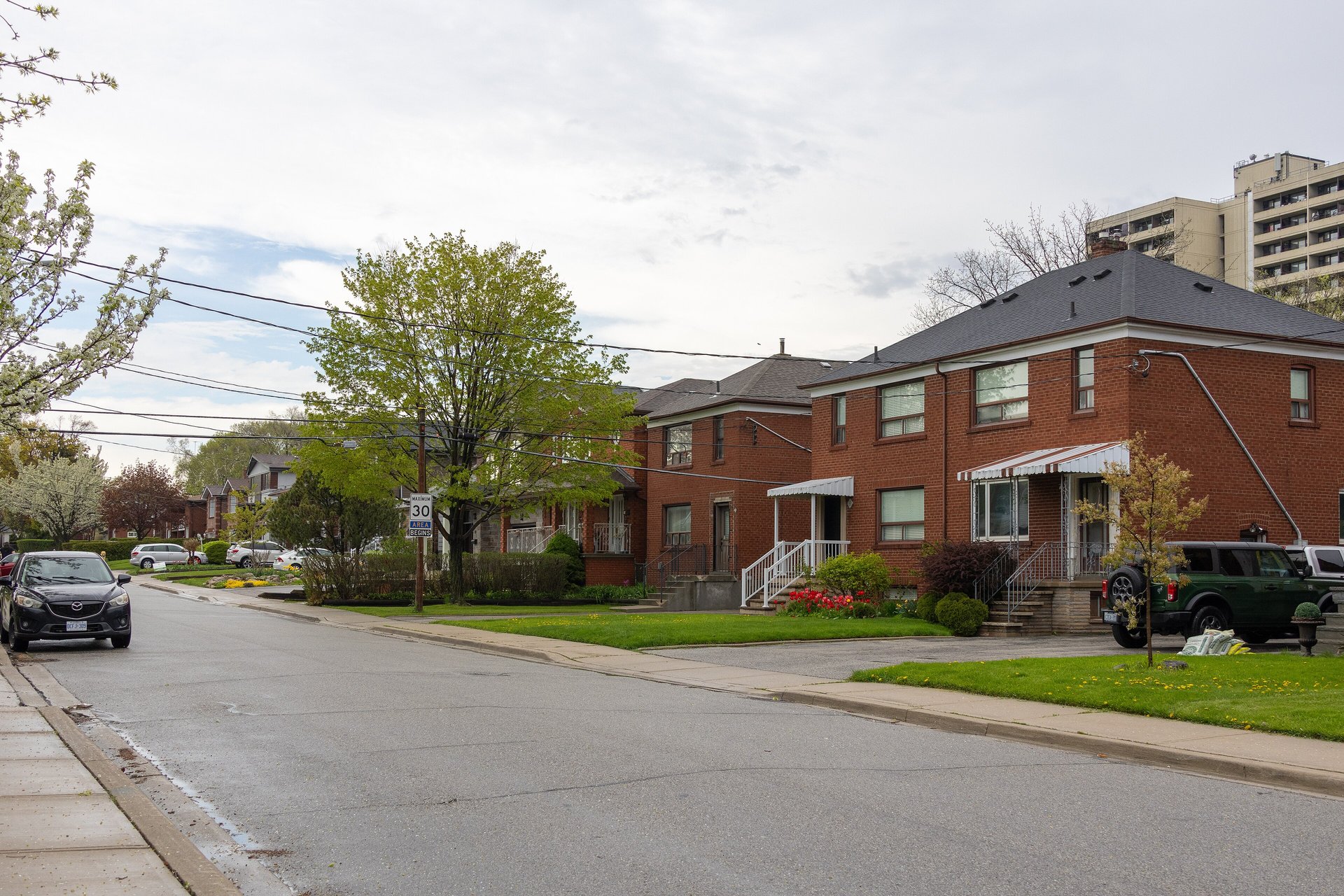 Two-storey red-brick low-rise homes along Harold Street in Mimico, Etobicoke, Toronto