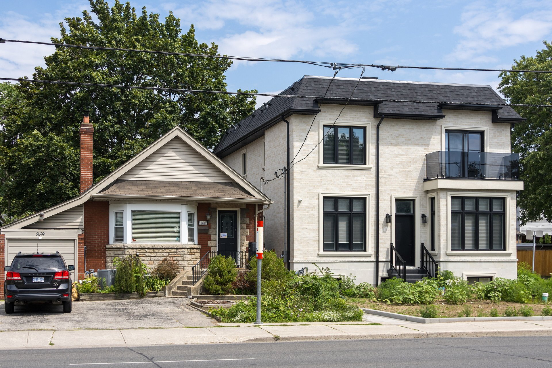 Small older brick bungalow next to a modern rebuilt house on Coxwell Avenue in East York, Toronto