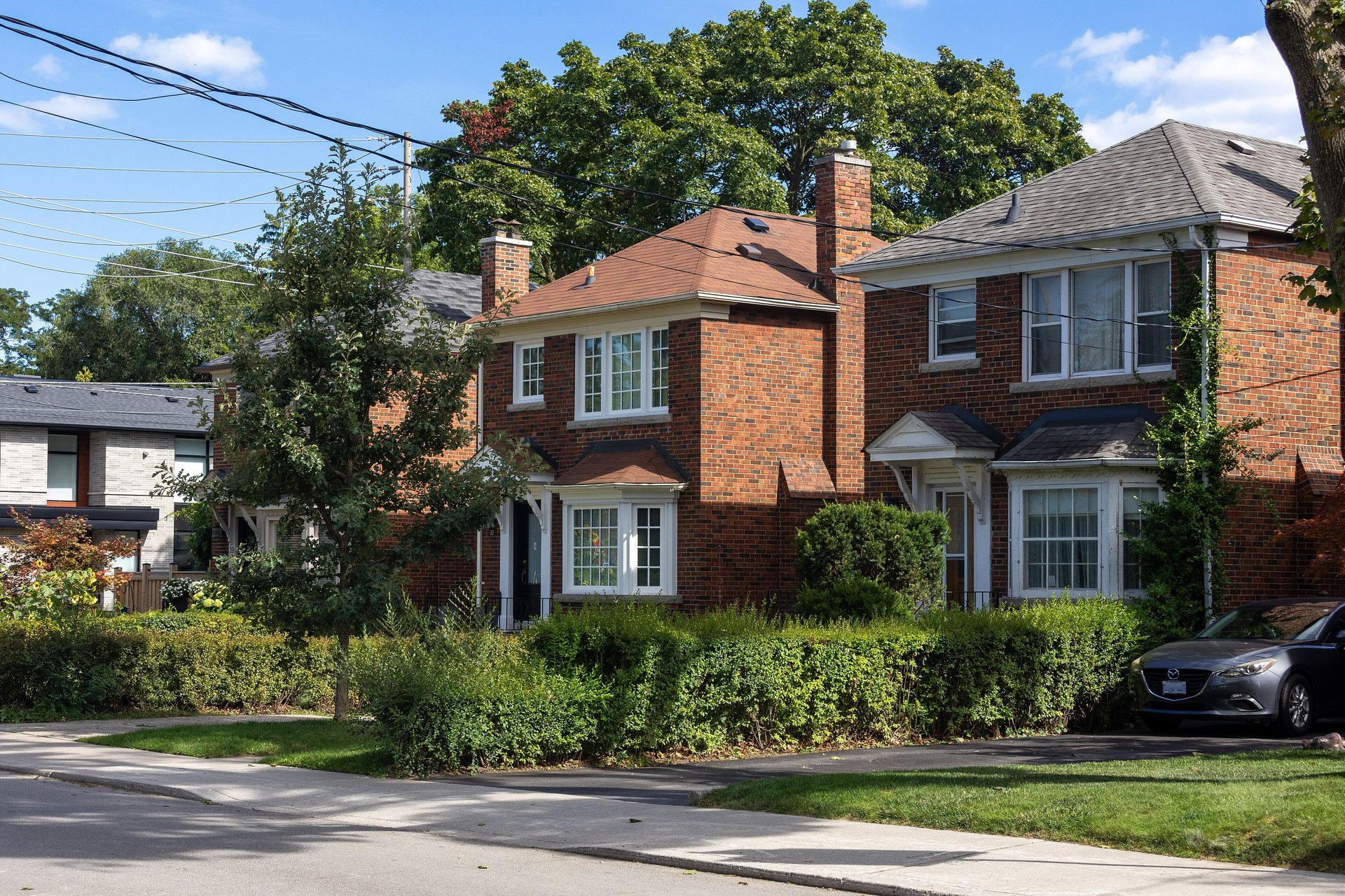 Red-brick two-storey detached houses on Rumsey Road in Leaside, Toronto