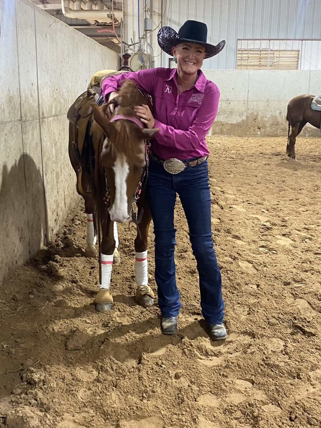 Kendra Dickson (KD) with a horse in the arena