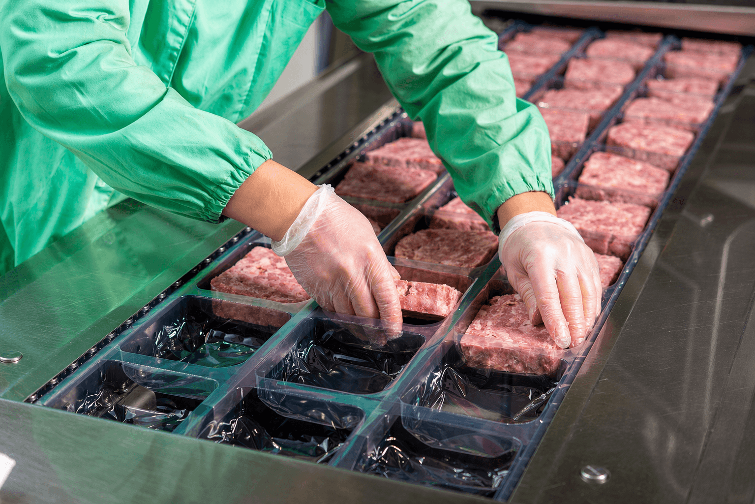 Ground beef being packaged on a meat processing line