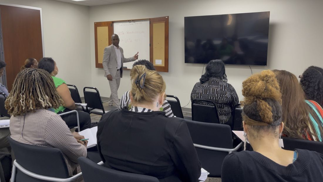 Adults listening during one of Dwayne's community workshops