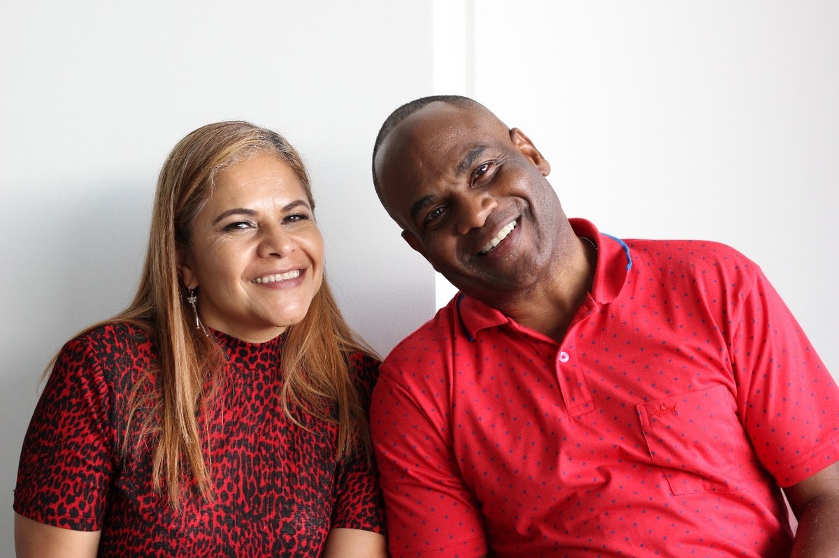 Patty and Dwayne Golden smiling together in matching red
