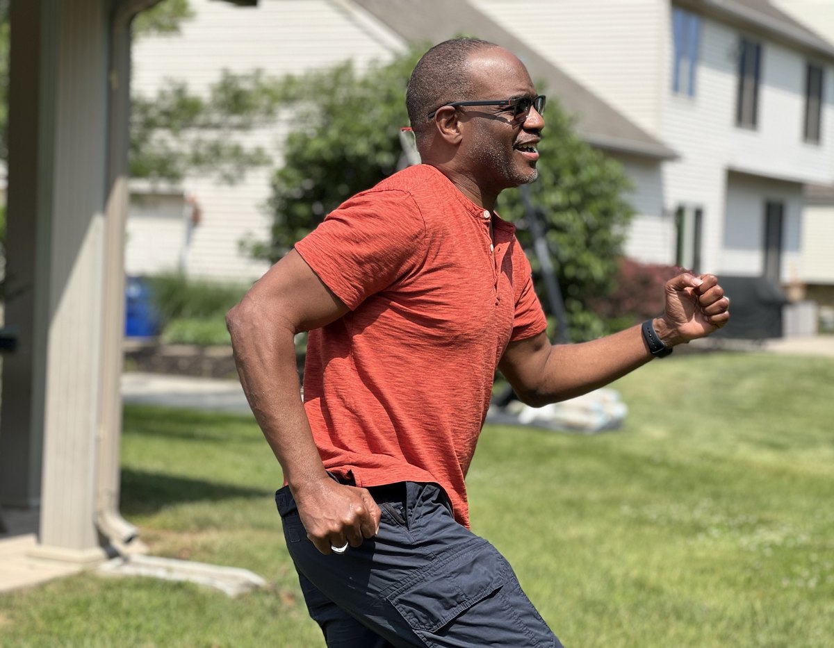 Dwayne Golden jogging across a sunny lawn