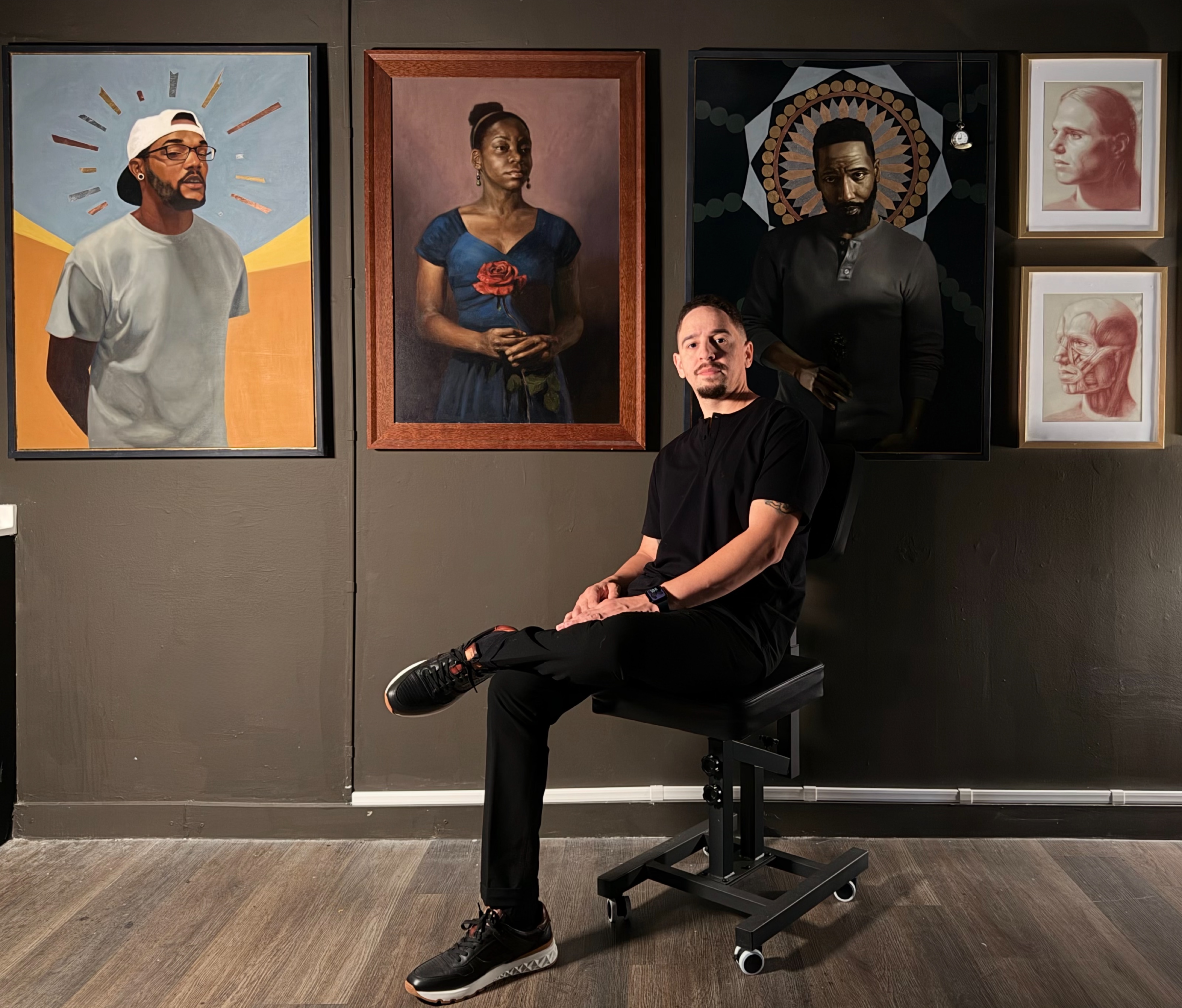 Eric Bess seated in front of his artwork