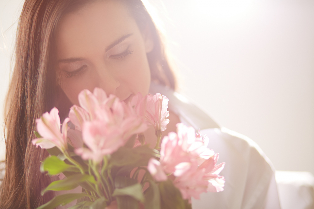 Woman sniffing flowers
