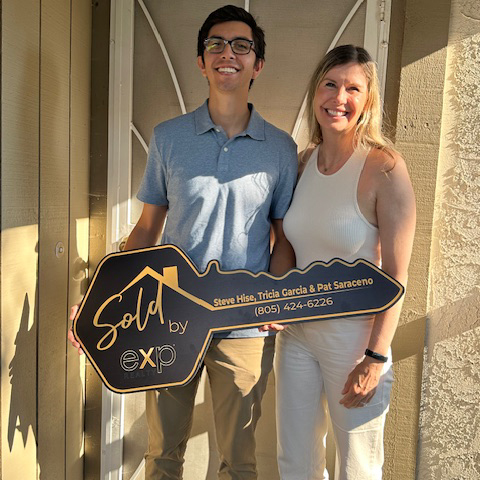 Happy home sellers with sold sign in Moorpark, CA, Real Estate Toolbox client