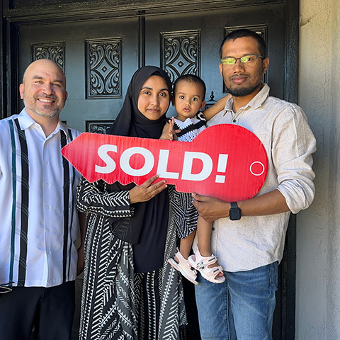 Happy family with sold sign in Chatsworth, CA, Real Estate Toolbox client