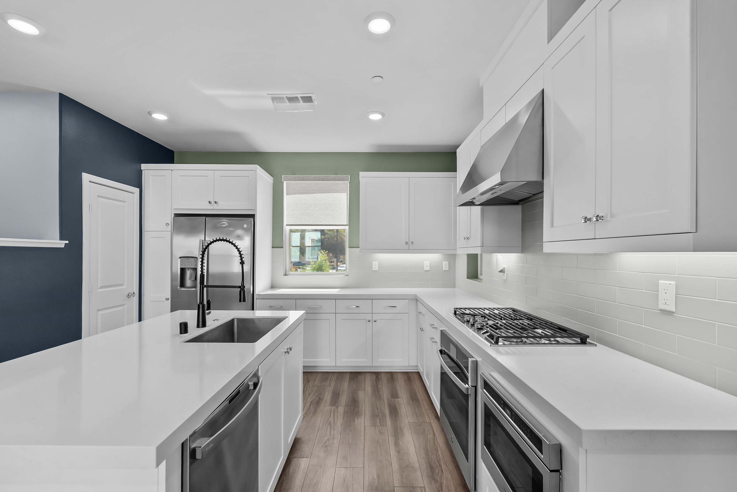 Gas cooktop, wall oven, and subway tile