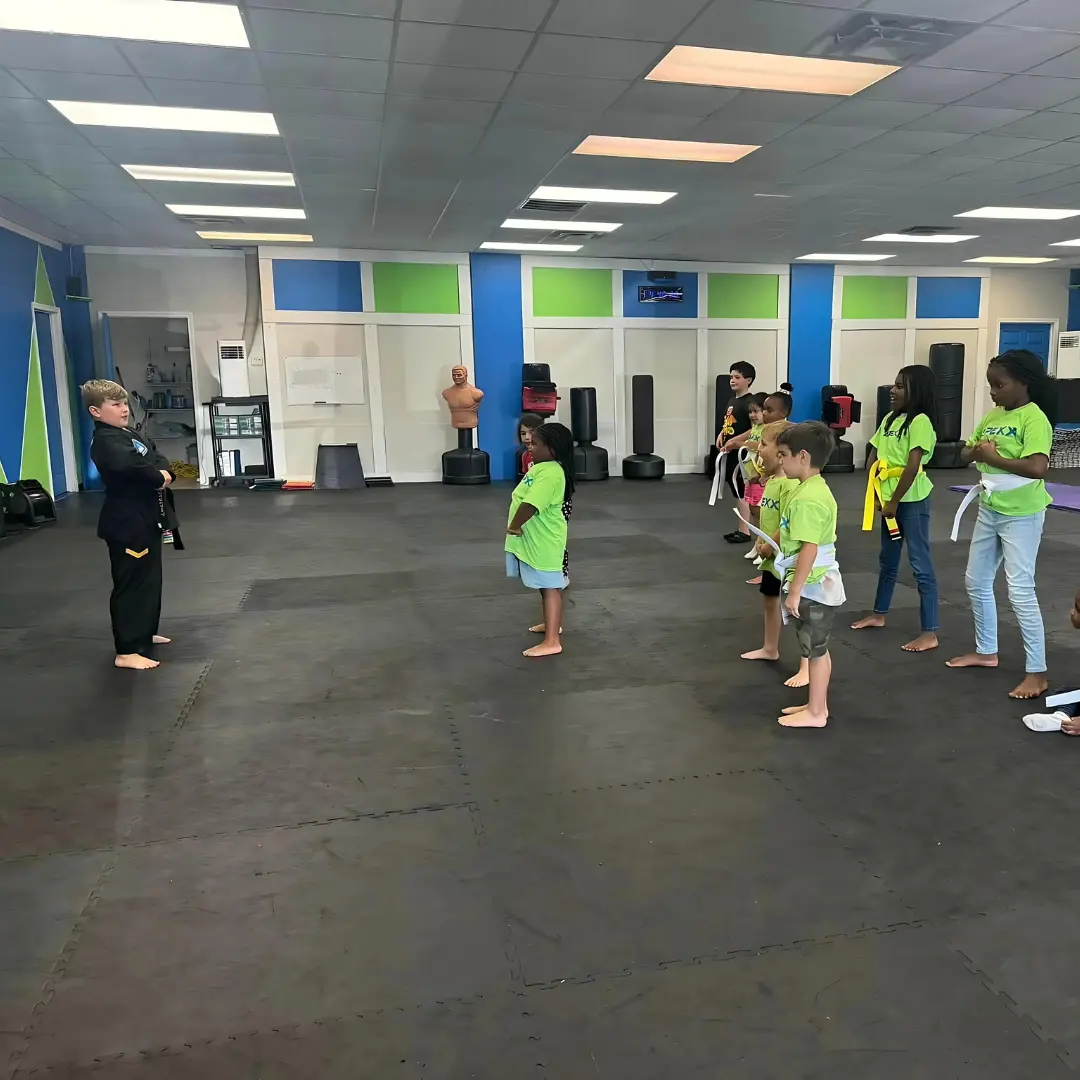 Kids participating in martial arts training at Apexx after-school program.