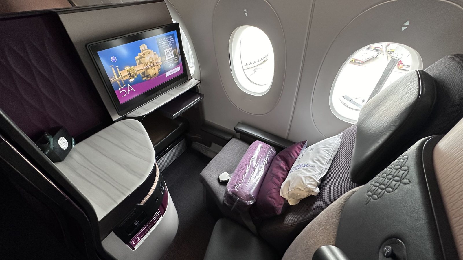 A business class seat by the window