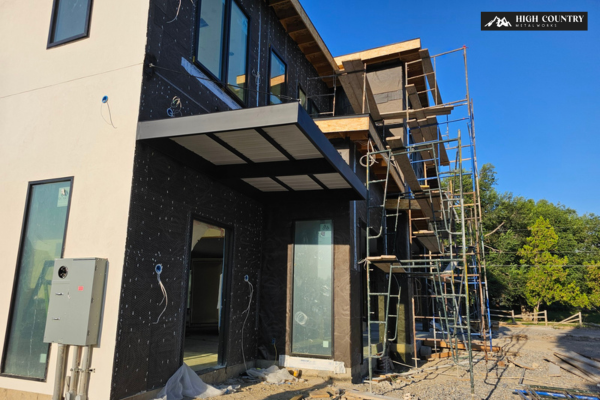 Exterior view of a home under construction showcasing custom steel frames for canopies and awnings in Utah storefronts.